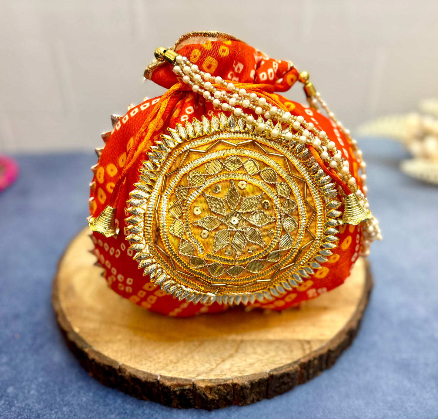 Orange Bhandhej Silk Potli with Pearl Handle